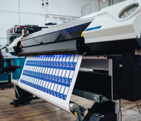 An industrial large format printer in use in a manufacturing facility. An industrial large format printer in use in a manufacturing facility.