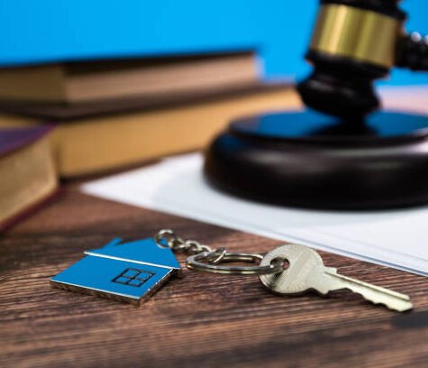 Gavel and house key on the table. Gavel and house key on the table.