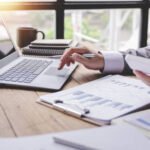 Tax2 Portrait of a businessman working on a tablet computer in a modern office. Make an account analysis report. real estate investment information financial and tax system concepts